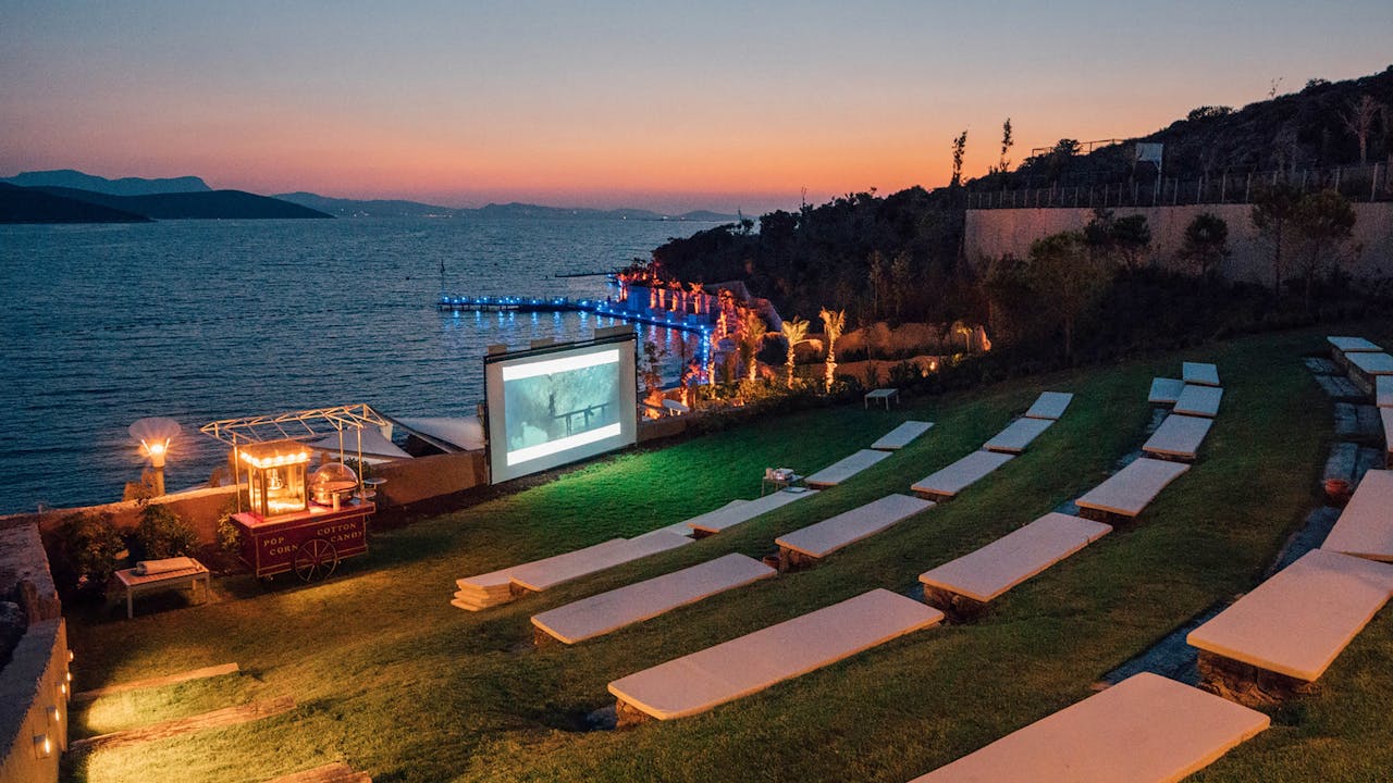 Beautiful evening outdoor movie setup by the sea in Bodrum, Turkey.